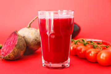 Glass of fresh vegetable juice on color background