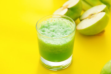 Glass of fresh vegetable juice on color background