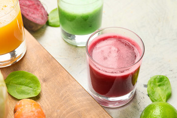 Glasses of fresh vegetable juice on table