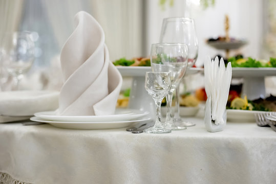 Server Table Plate Knife Fork And Wine Glasses At The Banquet. Luxurious Elegant Dinner At The Table In The Restaurant. Holiday Table Decoration