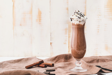 Glass of tasty chocolate milkshake on table