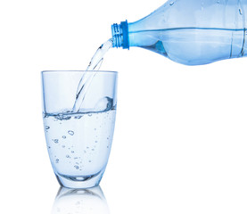 Pouring of fresh water in glass on white background