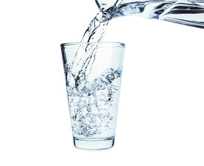 Pouring of fresh water in glass on white background
