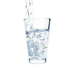 Pouring of fresh water in glass on white background