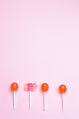 Tasty lollipops on color background
