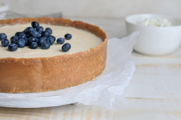 Sweet tasty cheesecake on table