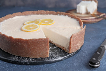 Sweet tasty cheesecake on table
