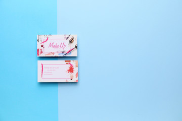 Business cards of makeup artist on color background