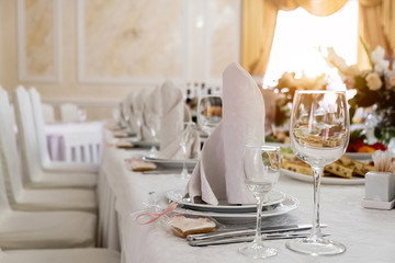 Wine glasses and glasses on the server table.Luxurious elegant dinner at the table in the restaurant. Holiday table decoration