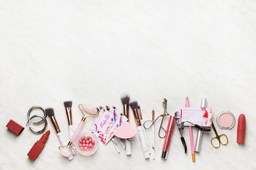 Decorative cosmetics and accessories with business cards of makeup artist on white background