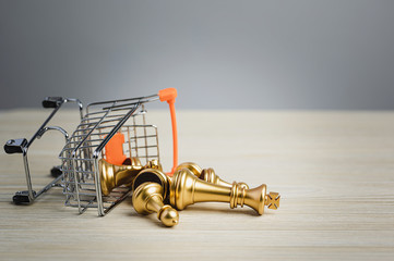 Falled chess figure in shopping cart. Failure of strategy. Business marketing strategy, leadership, management idea, success achievement and organization concept.