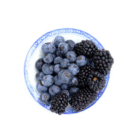 Blueberry and Blackberry on blown cup with white background, fruit concept