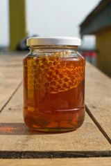 Real Fresh Honey with Honeycomb in the Glass Jar. 