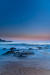 Naklejka premium Iridescent Blue Dawn Seascape with Crescent Moon