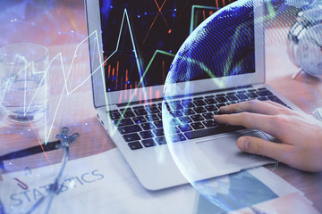 Multi exposure of market chart with man working on computer on background. Concept of financial analysis.