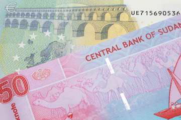 A five Euro, European Union bill with a fifty pound note from Sudan close up in macro