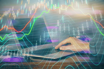 Multi exposure of stock market graph with man working on laptop on background. Concept of financial analysis.