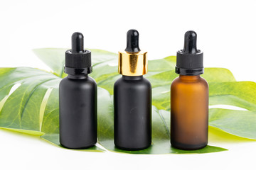 Natural  cosmetics concept: Cosmetics with grean leaves isolated on white