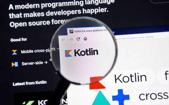 Kotlin example code, site and logo under magnifying glass