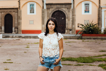 Fototapeta premium Mexican woman portrait looking happy and smiling in a colonial city in Mexico City