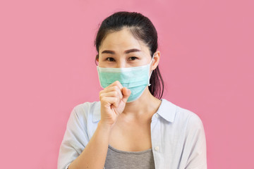 Young asian woman worea gray tank top, Blue shirt and protective masks against virus and air pollution,make gesture Coughing, isolated on pink background