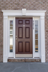Traditional pre-hung mahogany front door with two sidelite panels adjustable sill, ball bearing hinges, key lock, surrounded by white decorative frame with elegant luxury trimming