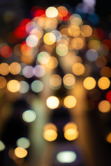 Blurred footage. Traffic jam on a wide street. Blurry brake lights. Dense city traffic. Transport interchange. Night footage.