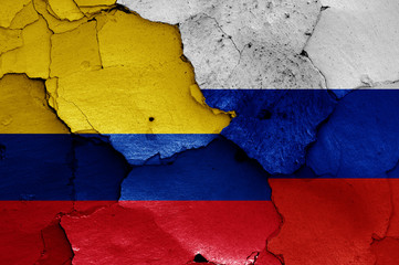 flags of Colombia and Russia painted on cracked wall