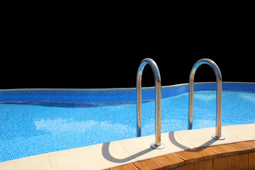 Swimming pool at high class resort on black background isolated
