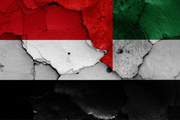 flags of Yemen and UAE painted on cracked wall