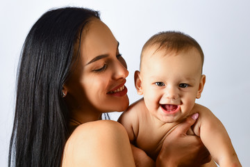 Happy family mother playing with newborn baby.Happy smiling face. Loving mother. Mothers day concept. Happy smiling mother with baby over white background.