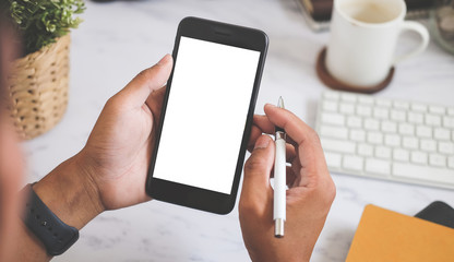 Cropped shot view of man hands holding smart phone with blank copy space screen for your text message or information content, female reading text message on cell telephone during in urban setting. 