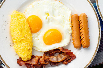 American breakfast with sunny side up eggs, bacon