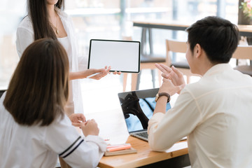 Obraz premium Group young business man and woman working on laptop in co-working space, freelancer using computer in workspace environment.