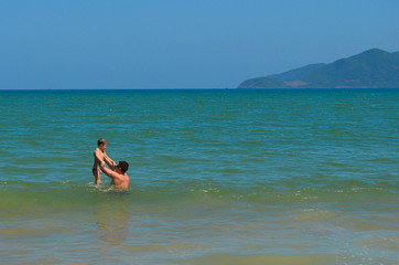 Father and son are swimming in the sea on a summer lifestyle vacation . Tourist destination