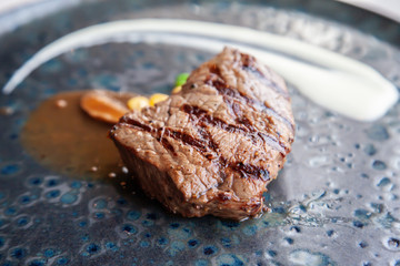 Grilled juicy beef steak with white sauce