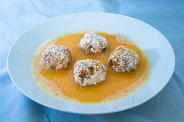Roll the arancini ball inside the egg