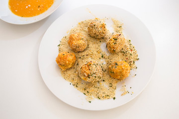 Roll the arancini ball in the breadcrumbs