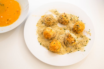 Roll the arancini ball in the breadcrumbs