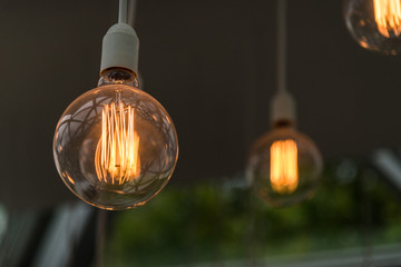 Vintage antique hanging light bulbs. Holidays and business good idea concept.