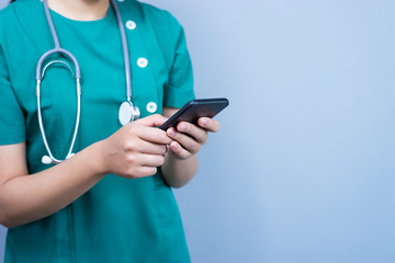 isolated close up body shot of female doctor holding a smart phone with her finger touching the...