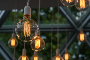 Vintage antique hanging light bulbs. Holidays and business good idea concept.