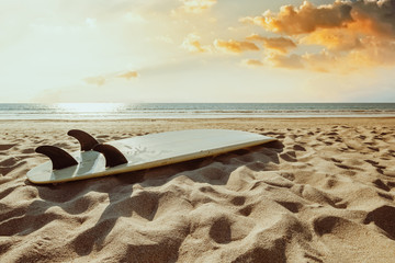 Surfboard on beach background at sunset. Travel adventure and water sport.  retro color tone effect.