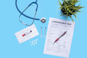 layout of health and medical care testing for checkup on patients with virus, with stethoscope, plant pot, pen, facemask, test tube and document testing on corona virus, on blue flat lay background