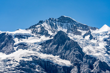 Switzerland, Panoramic view on Eiger, Monch and Jungfraujoch and green Alps around Mannlichen