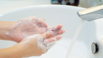 Wash hands.Hygiene concept Wash your hands with soap in the sink.Cover for virus protection.