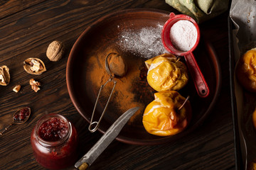 Baked apples with cinnamon, icing sugar and nuts. Home cooking.