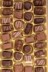chocolate candy set close-up.assorted chocolate sweets.Chocolate candies set in an open box. top view.sweet dessert closeup.gift box.Details sweets praline chocolate sweets.