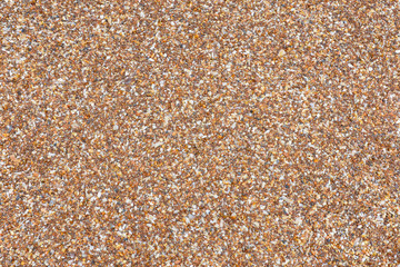 Sand background. Sand texture. Background of coarse sand. Brown sea sand.