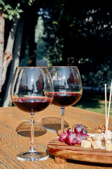 Glasses Of Fine Red Wine With Grape and Cheese